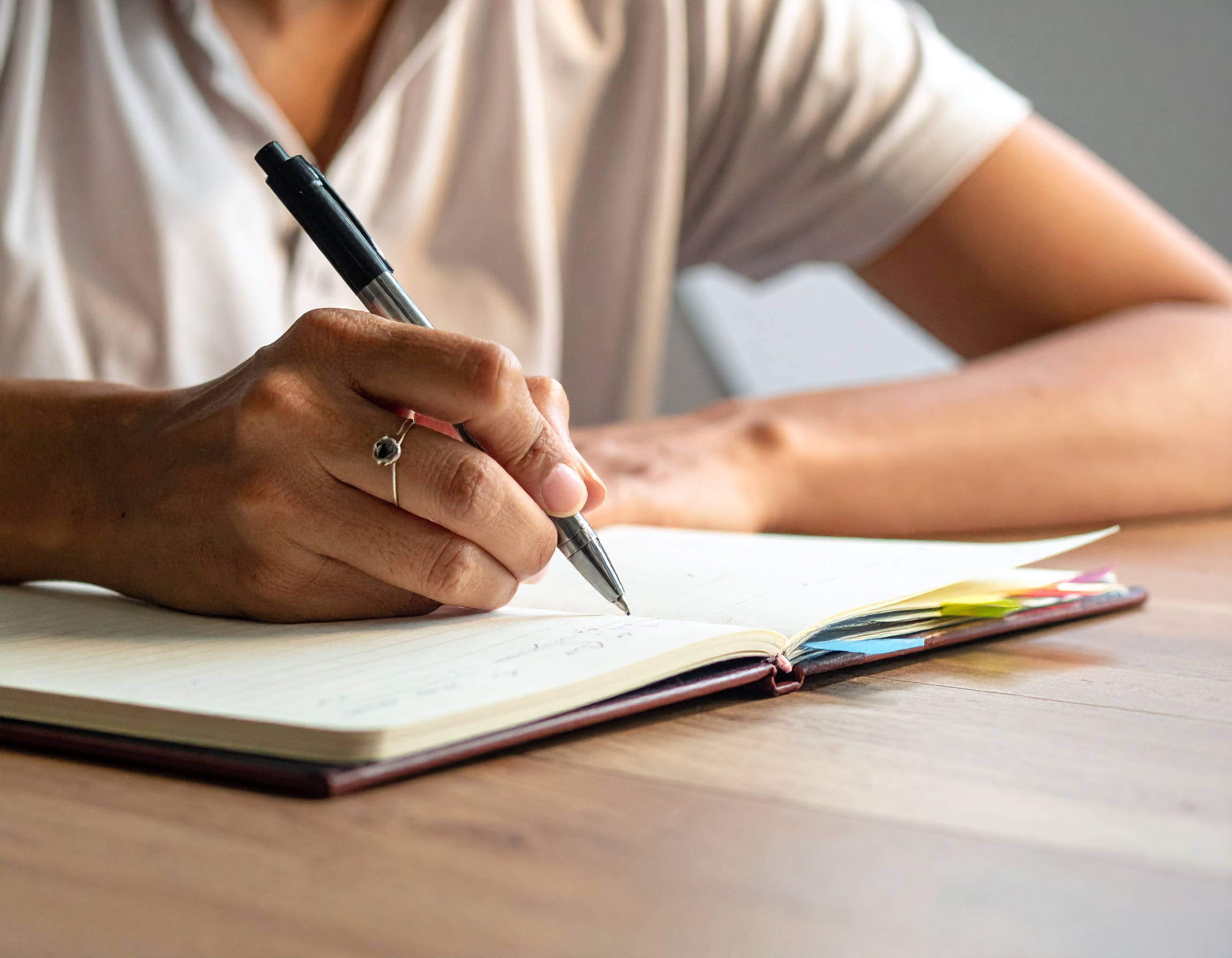 Person taking structured notes at a desk, preparing for a pre-interview visit as part of Panelling.