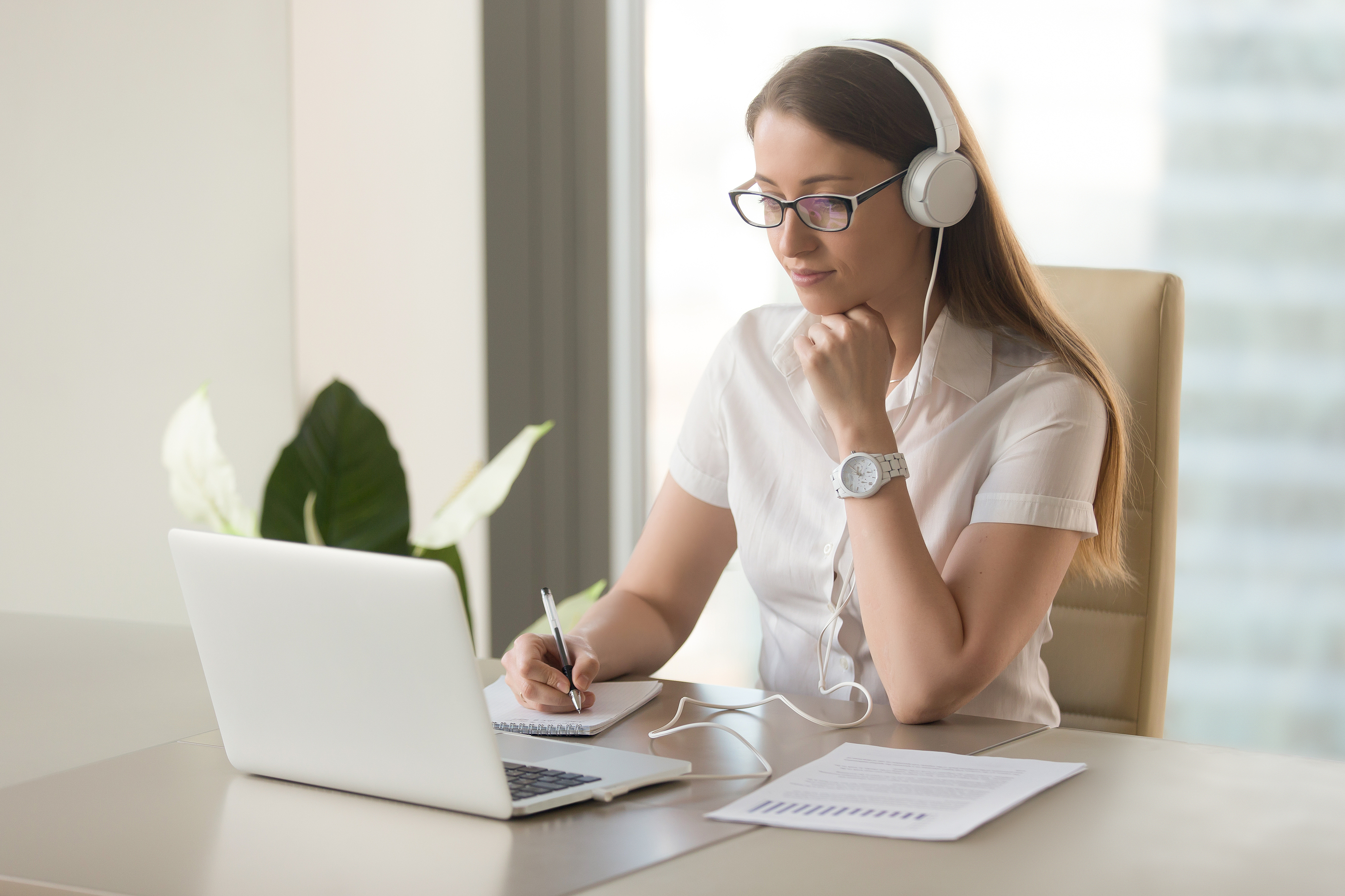 Junior doctor engaging with online learning content, studying key principles for structured consultant interview preparation using digital resources and checklists.
