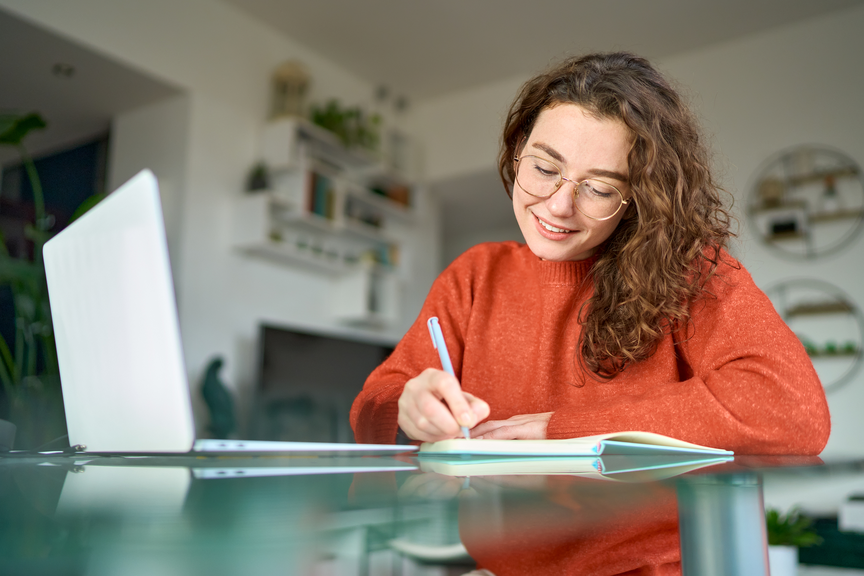 Person preparing for a consultant interview presentation by reviewing course materials and taking notes.