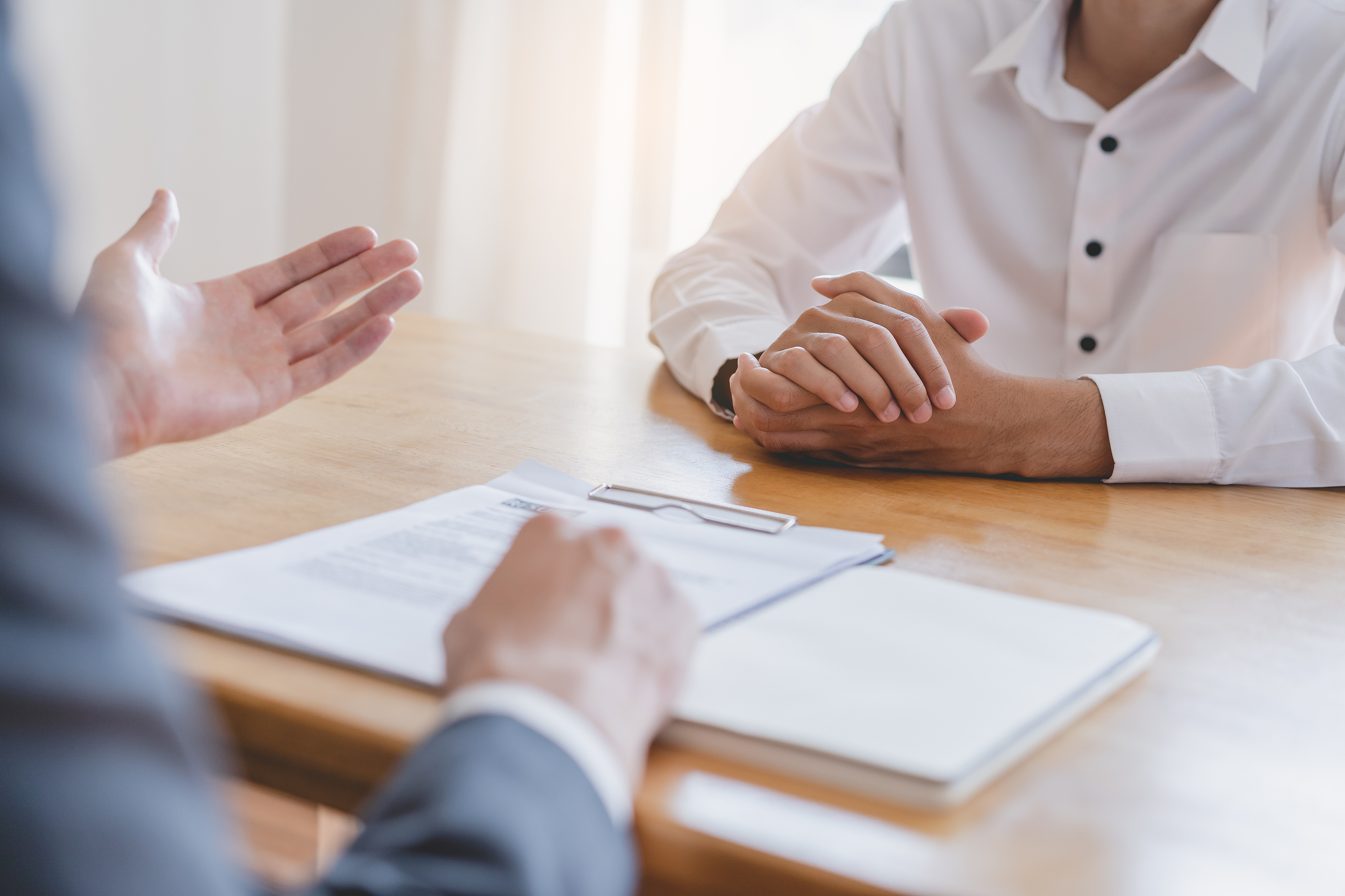 Conceptual image of an interviewer reviewing a CV, representing the process of pursuing and shortlisting candidates for consultant positions.